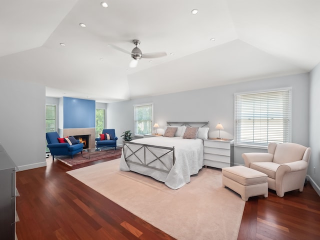bedroom with hardwood / wood-style floors, vaulted ceiling, and ceiling fan