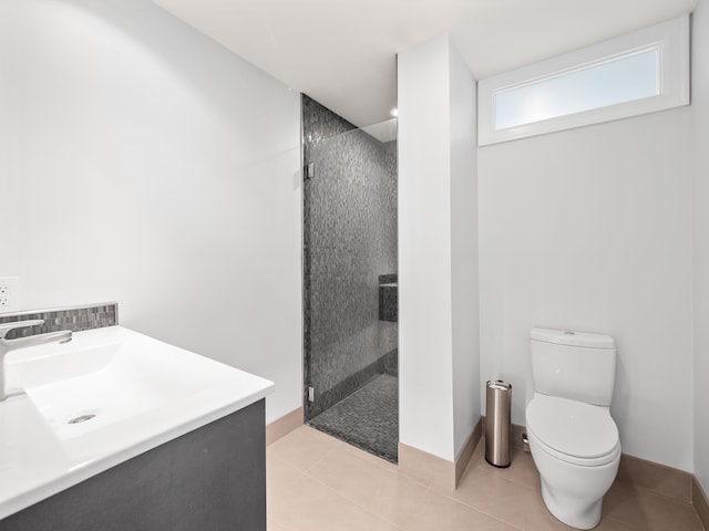 bathroom with walk in shower, tile patterned floors, toilet, and sink