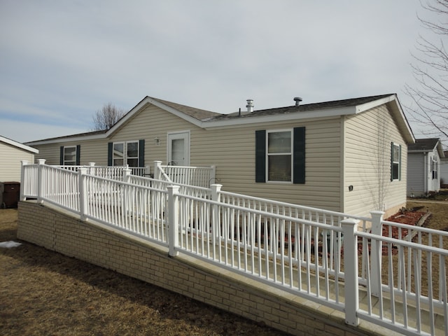 rear view of property with a wooden deck