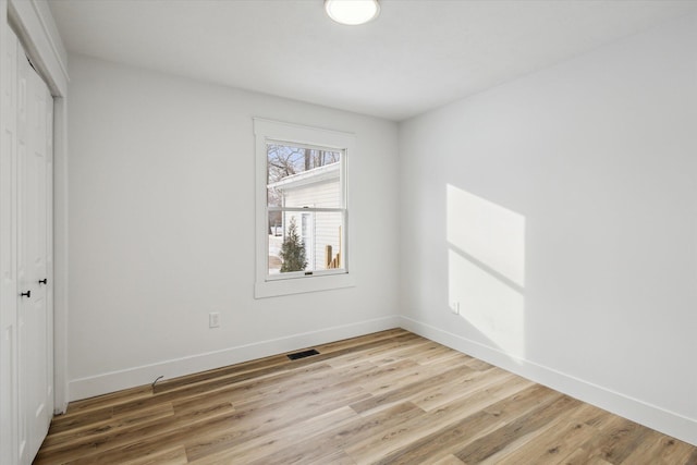 unfurnished bedroom featuring hardwood / wood-style floors and a closet