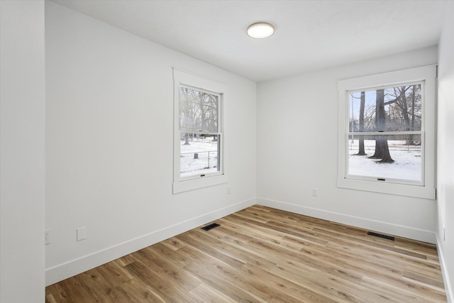 unfurnished room with light hardwood / wood-style floors