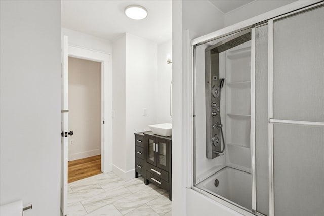 bathroom featuring vanity and shower / bath combination with glass door