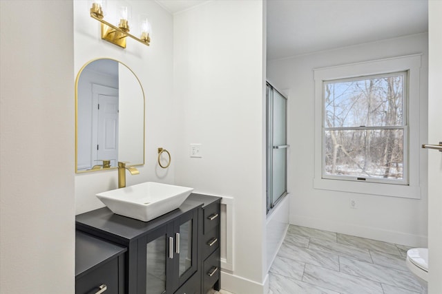 full bathroom with vanity, combined bath / shower with glass door, and toilet