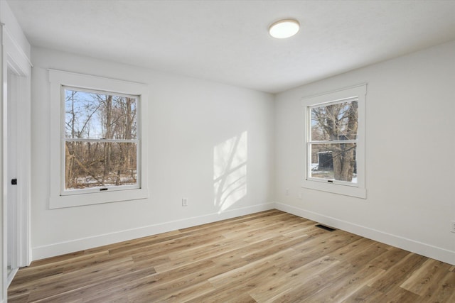 spare room featuring light hardwood / wood-style floors