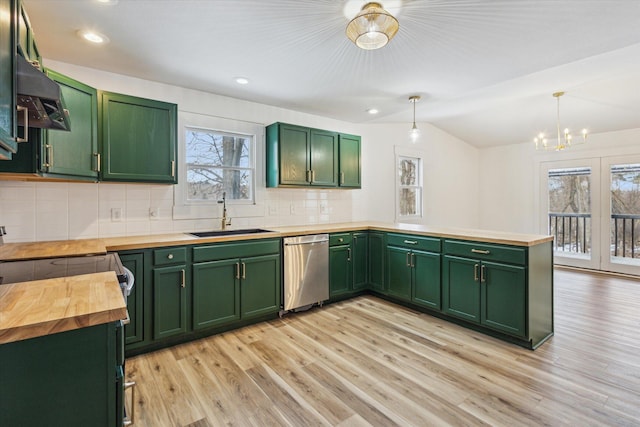 kitchen with wood counters, decorative light fixtures, dishwasher, sink, and green cabinets