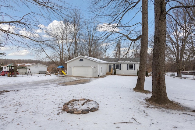 view of front of property with a garage and a playground