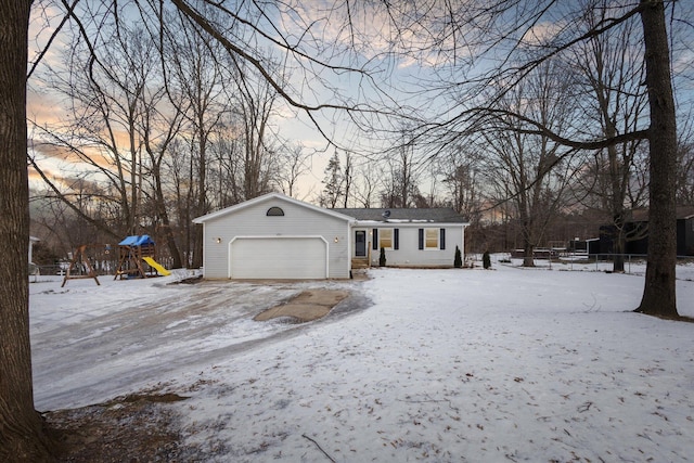 view of front of house with a playground and a garage