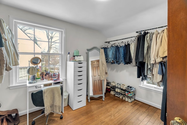 spacious closet with lofted ceiling and light hardwood / wood-style flooring