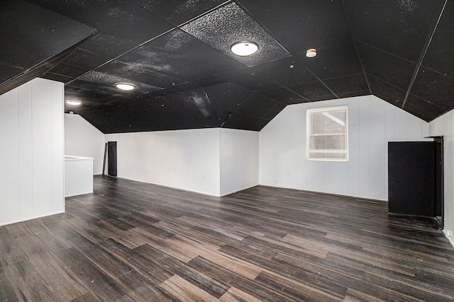 additional living space featuring lofted ceiling and wood finished floors