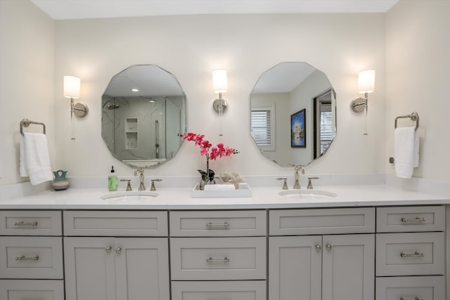 bathroom with a shower with door and vanity