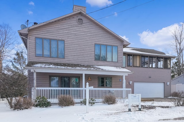 view of front of house featuring a garage and a porch