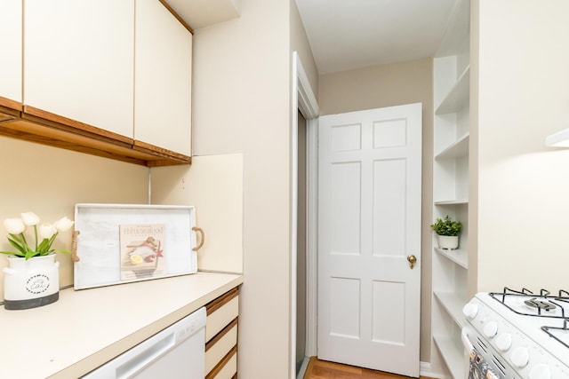 kitchen featuring white cabinets and white appliances