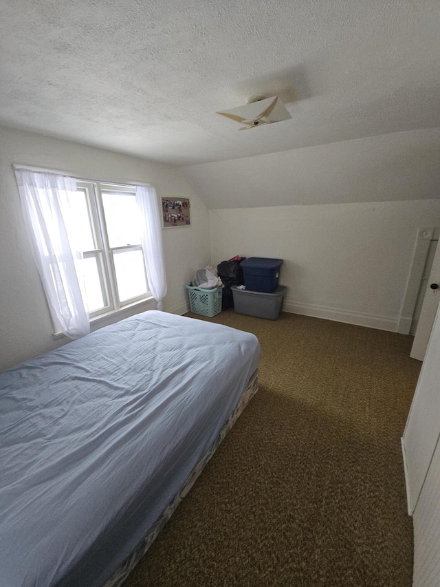 bedroom featuring carpet floors, lofted ceiling, a textured ceiling, and baseboards