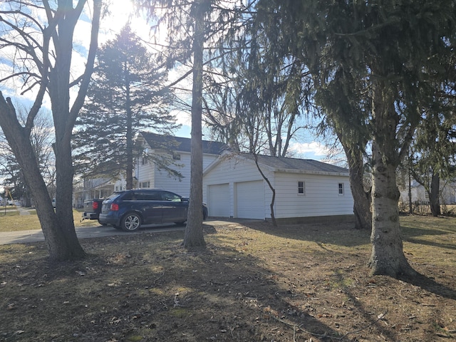 view of home's exterior with a detached garage