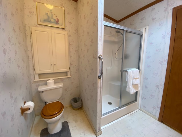 bathroom with crown molding, a textured ceiling, toilet, and walk in shower