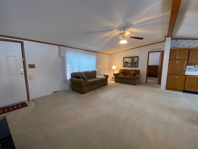 unfurnished living room featuring vaulted ceiling, ceiling fan, crown molding, light carpet, and a textured ceiling