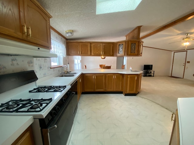 kitchen featuring black dishwasher, sink, gas range oven, kitchen peninsula, and a textured ceiling