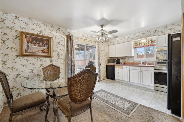 dining room with ceiling fan and sink