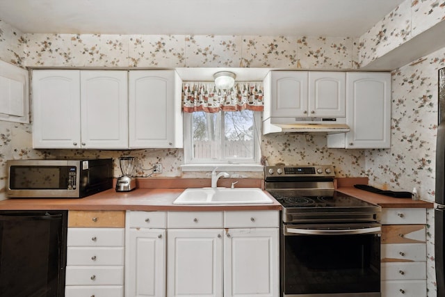 kitchen with appliances with stainless steel finishes, sink, and white cabinets