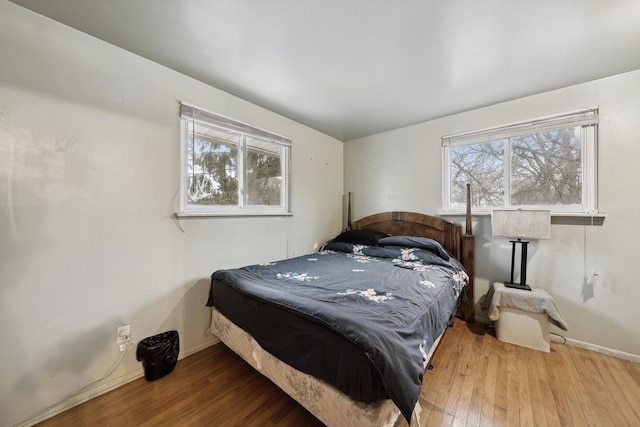 bedroom featuring hardwood / wood-style flooring and multiple windows