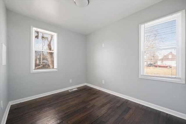 empty room featuring dark wood-type flooring