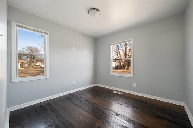 unfurnished room featuring dark hardwood / wood-style floors