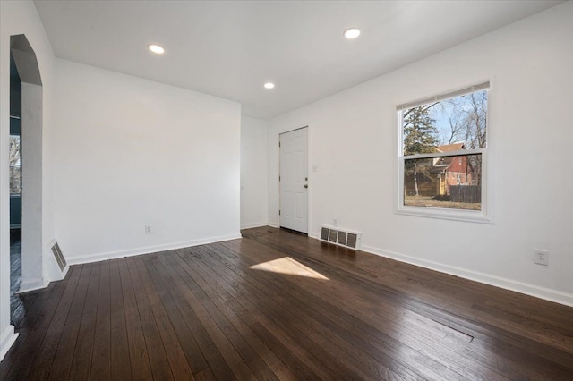 unfurnished room with dark hardwood / wood-style floors