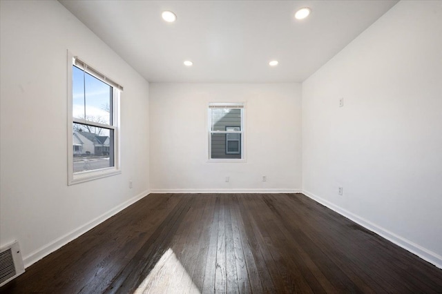 empty room featuring dark hardwood / wood-style flooring