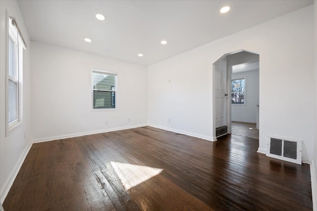 spare room with dark wood-type flooring