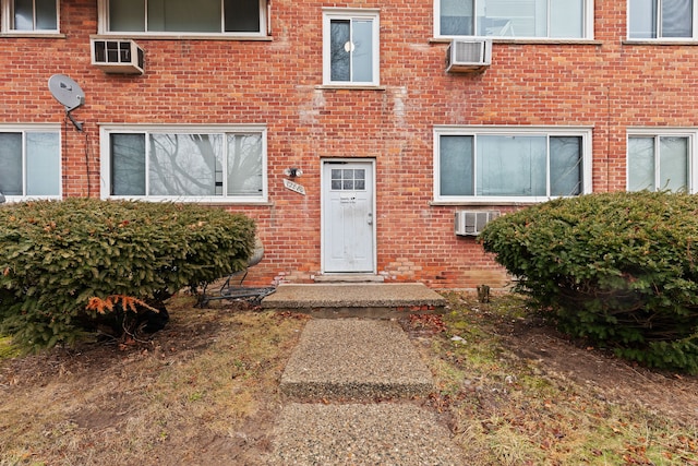 doorway to property featuring a wall mounted AC