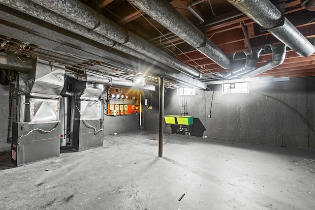 basement featuring sink and heating unit