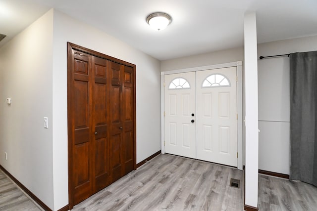 foyer entrance with light wood-type flooring