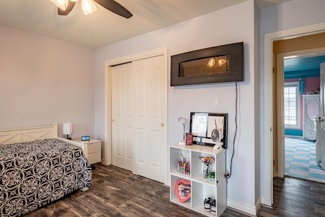 bedroom with dark wood-type flooring, a closet, and ceiling fan