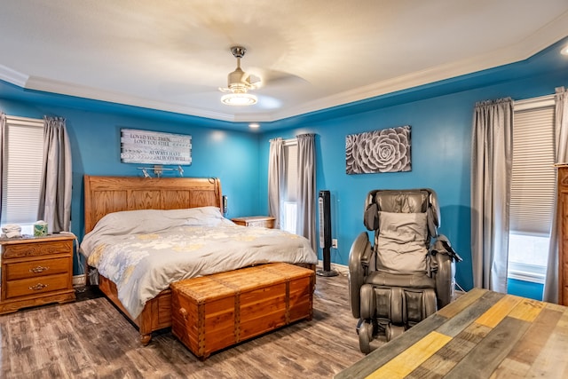 bedroom with ceiling fan, ornamental molding, and dark hardwood / wood-style floors