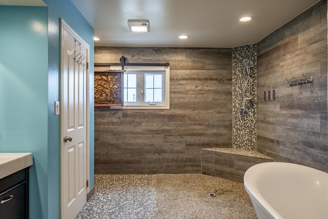 bathroom featuring vanity, wooden walls, and independent shower and bath