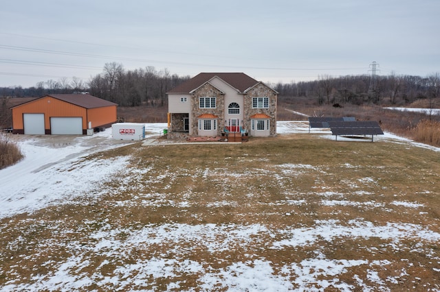 view of front of property featuring a garage and an outdoor structure