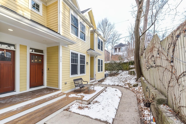 snow covered patio with central AC unit