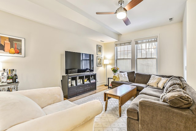 living room featuring light wood-type flooring and ceiling fan