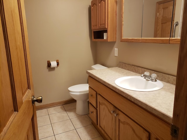 bathroom featuring tile patterned floors, toilet, and vanity