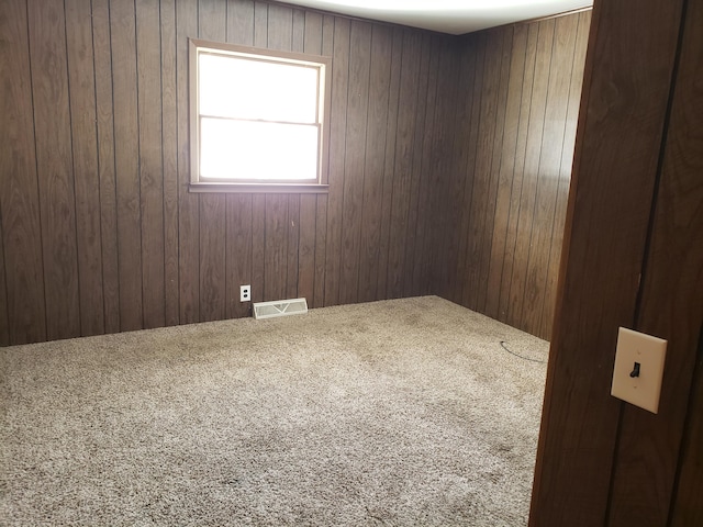 empty room featuring wood walls