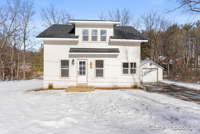 view of front of house featuring a garage and an outdoor structure