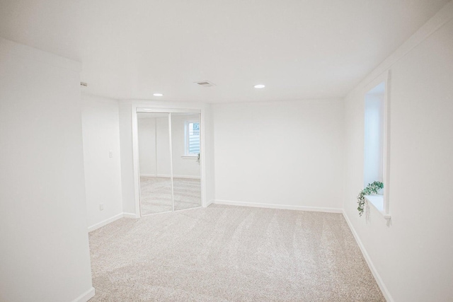 unfurnished room with light colored carpet