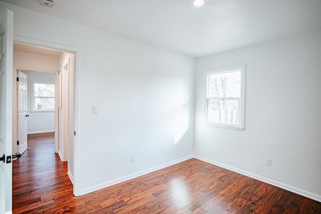 unfurnished room with hardwood / wood-style flooring