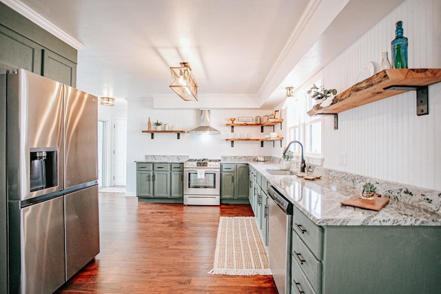 kitchen featuring sink, appliances with stainless steel finishes, dark hardwood / wood-style floors, green cabinetry, and wall chimney exhaust hood