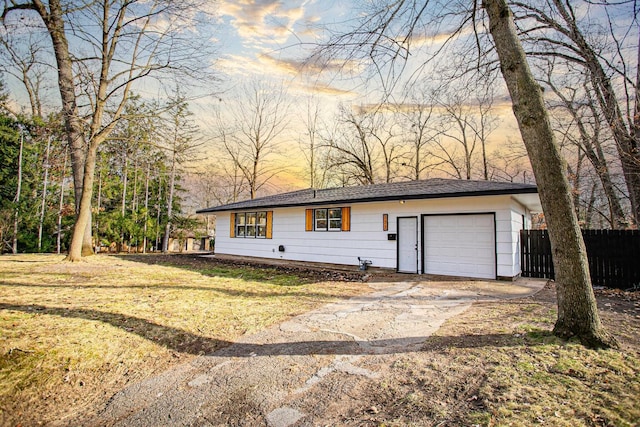 view of front of house featuring a garage and a lawn