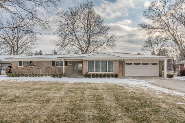 view of front of property featuring brick siding, an attached garage, and a front lawn