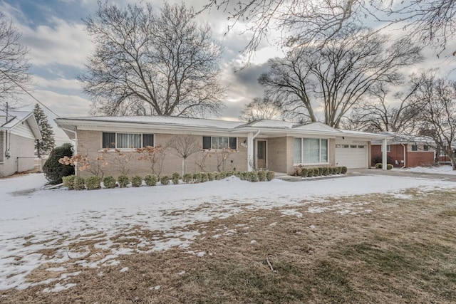 ranch-style home featuring brick siding and an attached garage