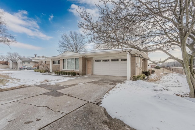 view of front of property with a garage, concrete driveway, and brick siding