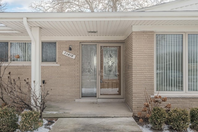 entrance to property with brick siding