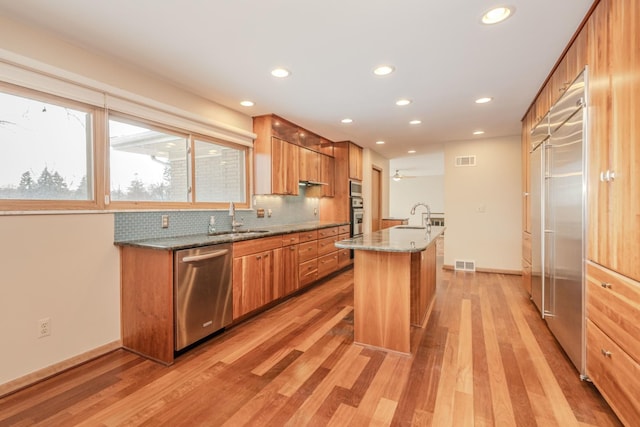 kitchen featuring appliances with stainless steel finishes, a sink, and visible vents